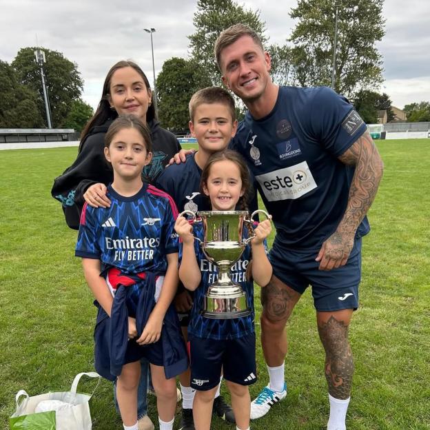 Jacqueline Jossa, Dan Osbourne, and their family on a soccer field.