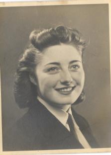 Black and white portrait of a smiling woman.