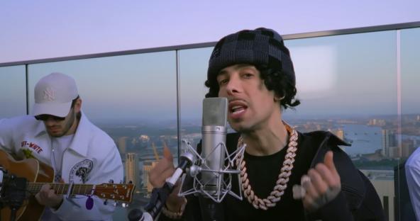Dappy recording music in a studio with a guitarist.