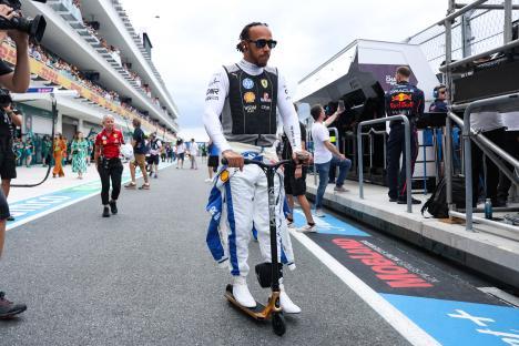 Lewis Hamilton riding a scooter at the Formula 1 Miami Grand Prix.