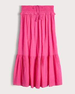Pink tiered maxi skirt with smocked waist and tassels.