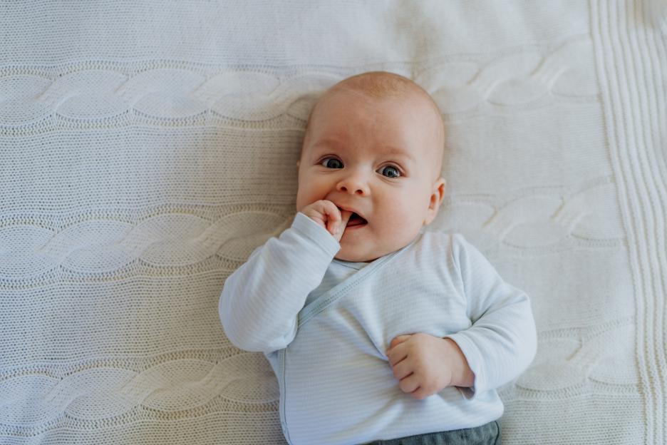 Portrait-newborn-baby-lying-bed-927487732