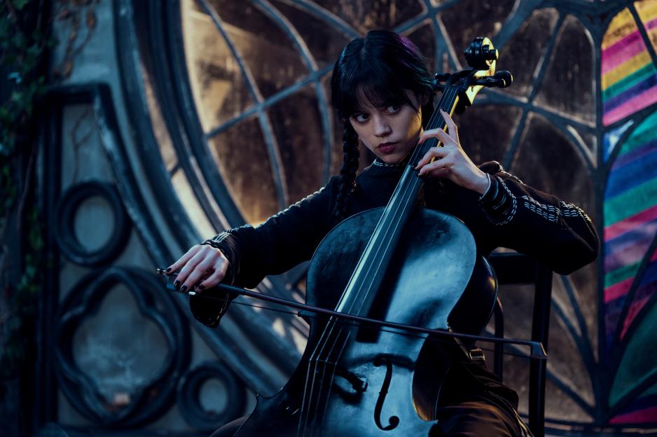Jenna Ortega as Wednesday Addams playing a cello.