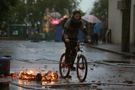 Thugs throw missiles on FOURTH night of violence as families forced to hide in attics in riots which injured 41 cops