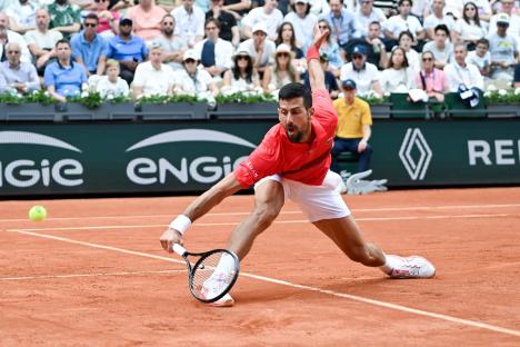 Novak Djokovic playing tennis at Roland Garros.