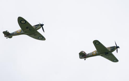 Two World War II-era fighter planes in flight.