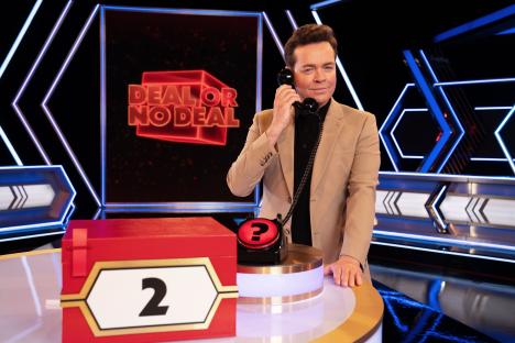 Stephen Mulhern on the set of Deal or No Deal, on the phone.