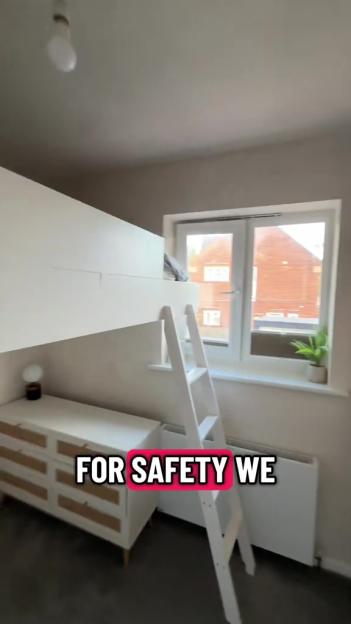 A small room with a white loft bed and a ladder, a window, and a white dresser with wooden drawers.