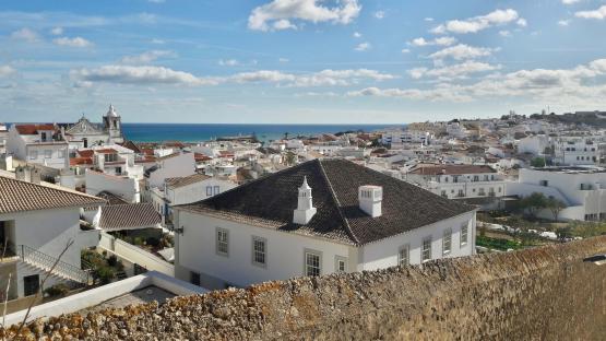 Overlooking Lagos, Portugal, showing whitewashed buildings, red tile roofs, and the ocean.