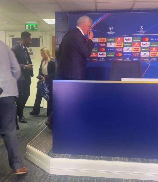 Jose Mourinho eating a cookie at a Champions League press conference.