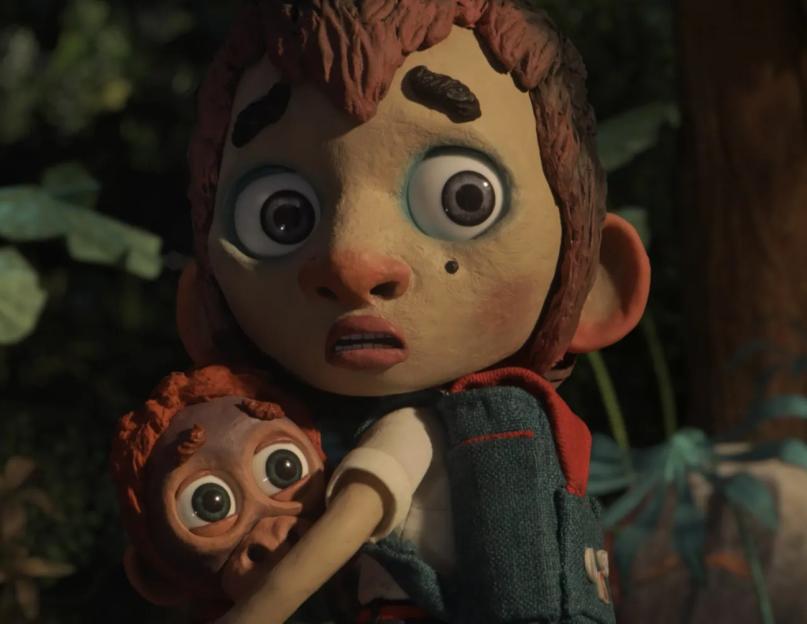 Still image from *Savages* of a worried-looking boy holding an orangutan.