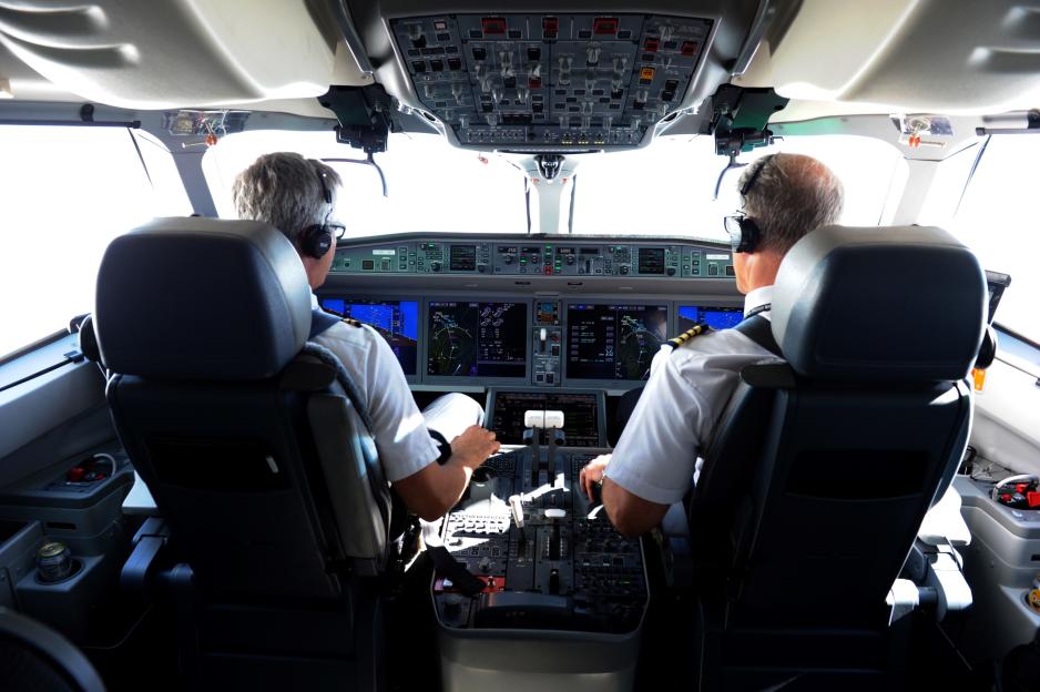 Two pilots seated in an airplane cockpit.