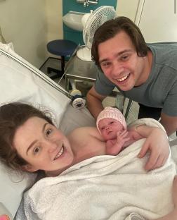 New parents with their newborn baby.