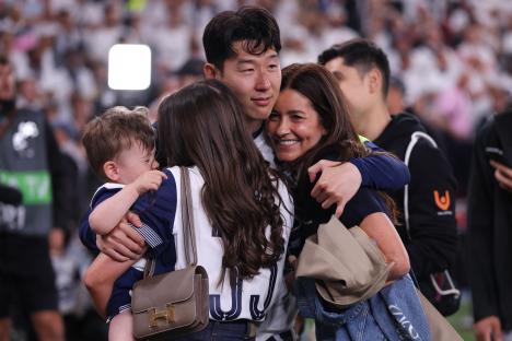 Son Heung-Min of Tottenham Hotspur celebrating with family after a game.