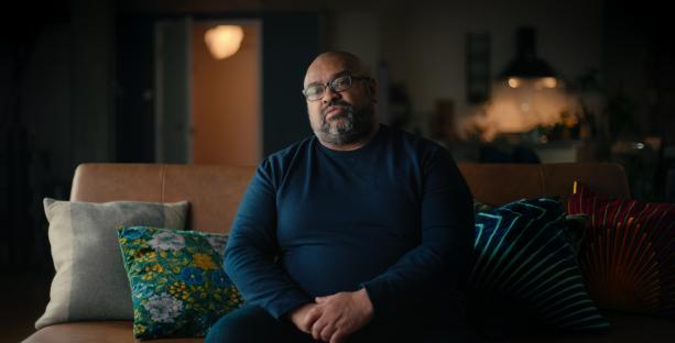 Graham Hornigold sitting on a couch.