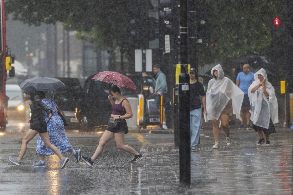 People walking in heavy rain in London.