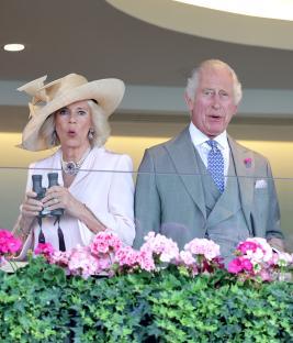 Queen Camilla and King Charles III at Royal Ascot, using binoculars.