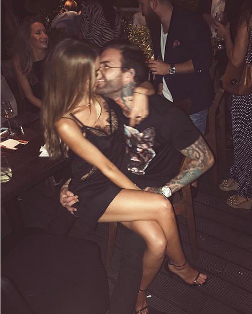 Lauren Pope sitting on Aaron Chalmers' lap.