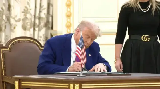Donald Trump signing a document.