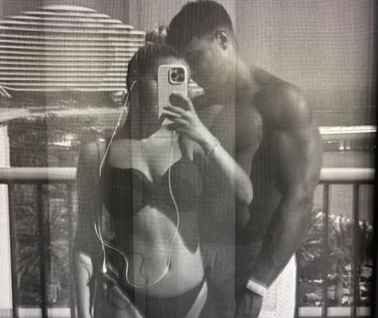 Black and white photo of Molly Mae Hague and Tommy Fury taking a selfie in swimwear.