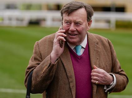 Nicky Henderson on his phone at the Cheltenham Festival.