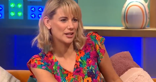 Woman in floral top on a talk show.