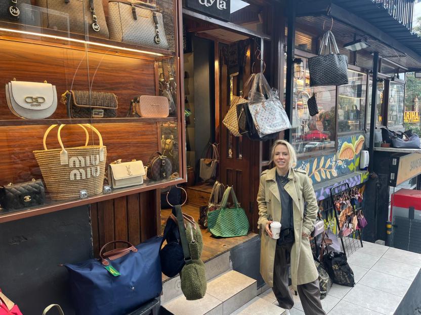 Clemmie Moodie standing outside a shop selling replica handbags in Istanbul.