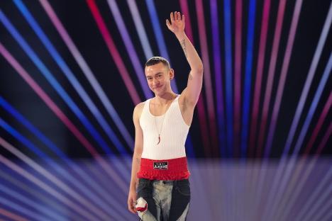 Olly Alexander waving on stage at Eurovision.