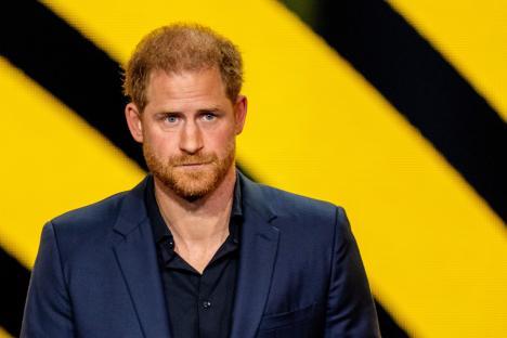Prince Harry in a dark blue suit.