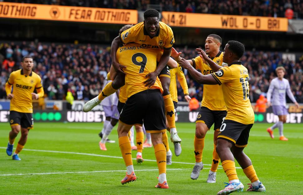 Wolverhampton Wanderers' Marshall Munetsi celebrates a goal with Jorgen Strand Larsen and other teammates.
