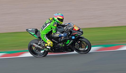 Motorcycle racer speeding on a track.