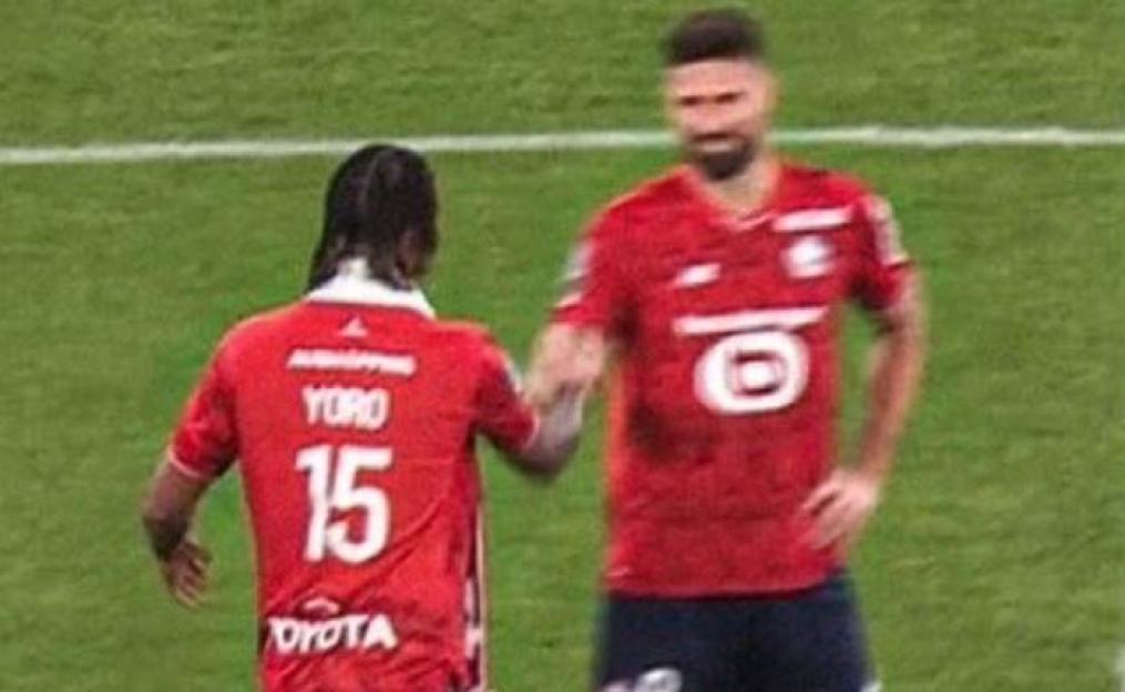 Leny Yoro, wearing a red jersey with "YORO" and "15" on the back, shaking hands with another player in a red jersey.