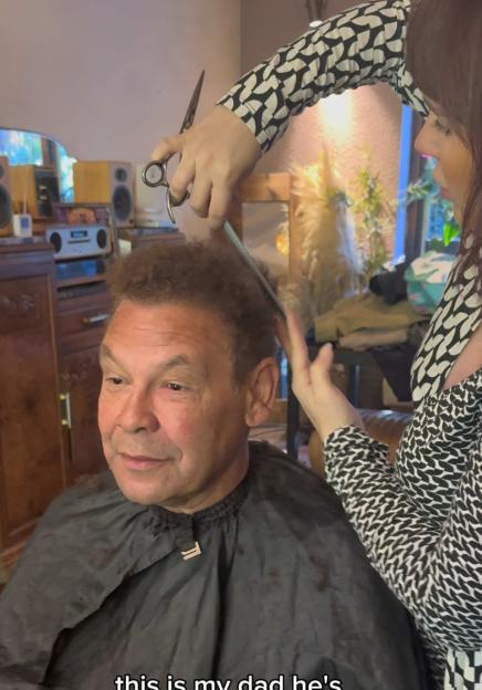 Craig Charles receiving a haircut from his daughter Anna-Jo Charles.