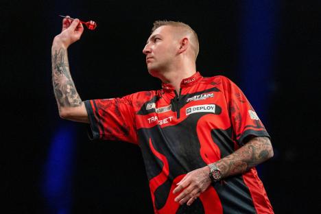 Nathan Aspinall throwing a dart.