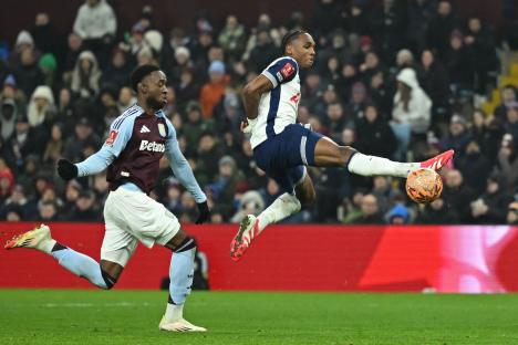 Photo of a soccer player kicking the ball during a game.
