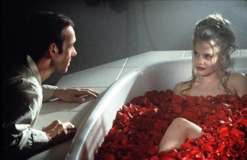 Scene from American Beauty: Kevin Spacey and Mena Suvari in a bathtub filled with rose petals.