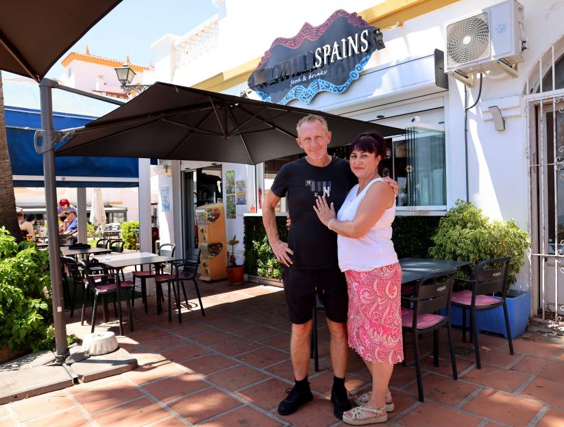 Photo of Andy Inman and Mayka Sanchez standing outside their bar, Weatherspains, on the Costa Del Sol.