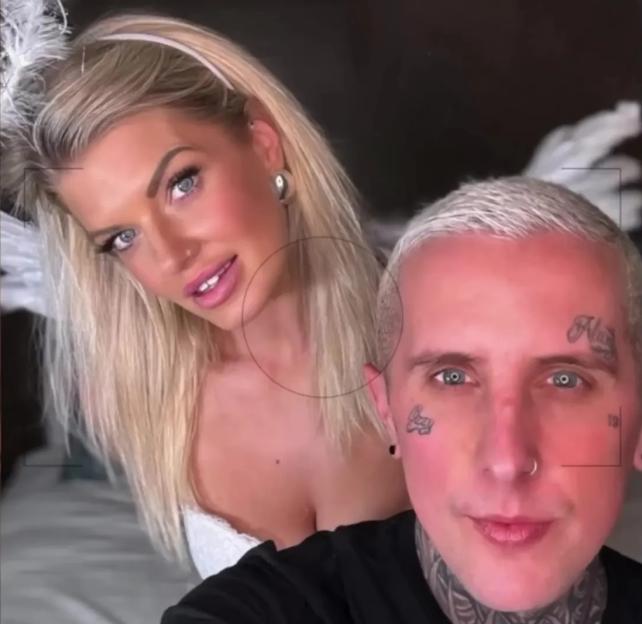 Photo of a man and woman posing together. The woman is wearing an angel costume.