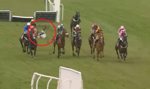 Jockey falling from horse during a horse race.