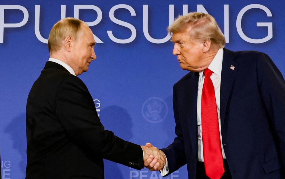 U.S. President Donald Trump and Russian President Vladimir Putin shake hands.