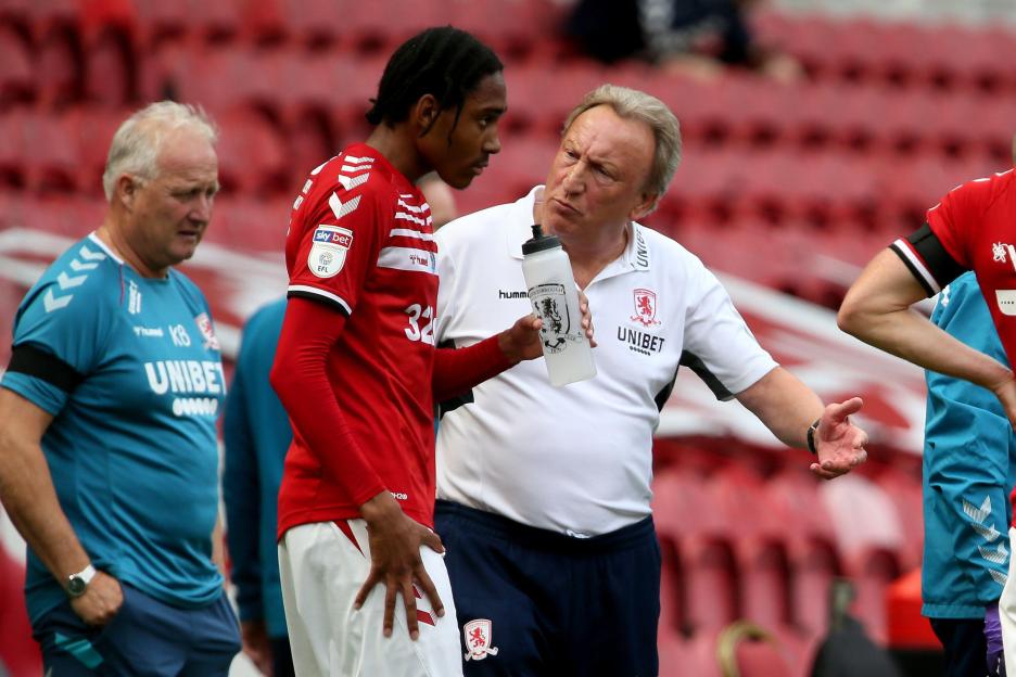 Middlesbrough manager Neil Warnock speaking with player Djed Spence.