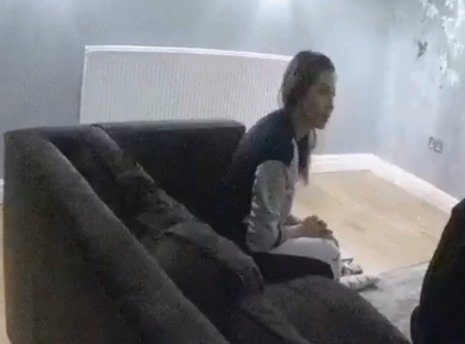 Woman sitting on a couch.
