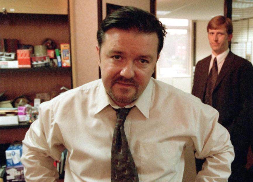 Ricky Gervais as David Brent with Martin Freeman as Tim Canterbury in the background.