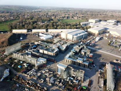 Aerial view of British film studio backlots under construction.