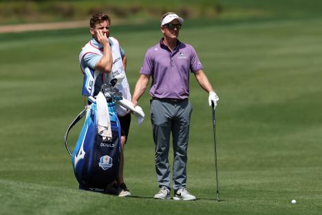 Luke Donald and his caddie Sam Matton on a golf course.