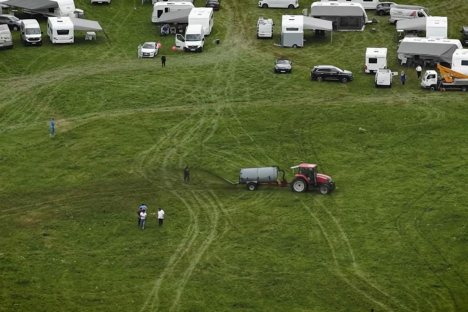 Moment furious French farmers use tractors to spray hordes of squatters with manure in drastic bid to get them off land