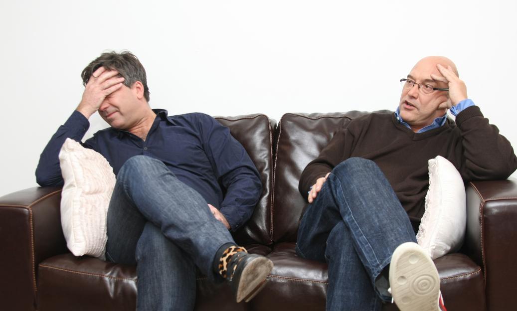 John Torode and Gregg Wallace sitting on a couch.
