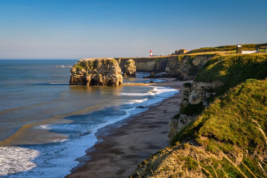 Marsden Bay beach with cliffs, sea stacks, and Souter Lighthouse.