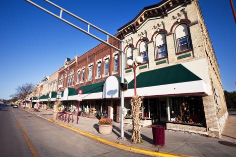 Sunny autumn day on a street with Victorian-style shops.