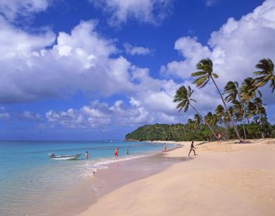 Beach scene with people swimming and relaxing on Darkwood Beach, Antigua.